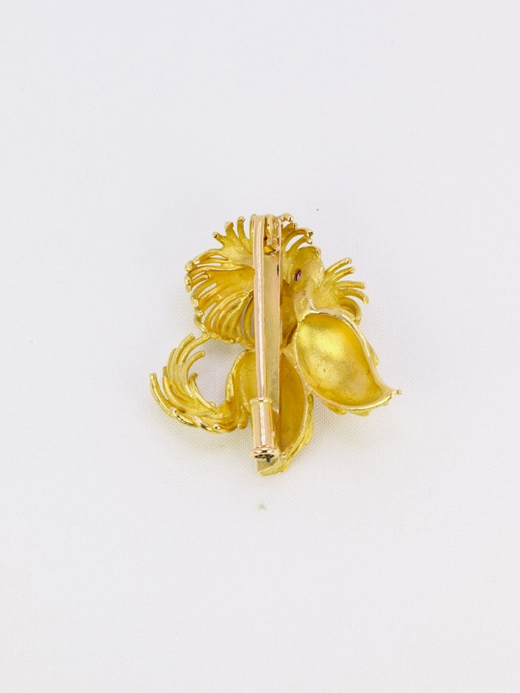 Broche animalière chien or jaune rubis