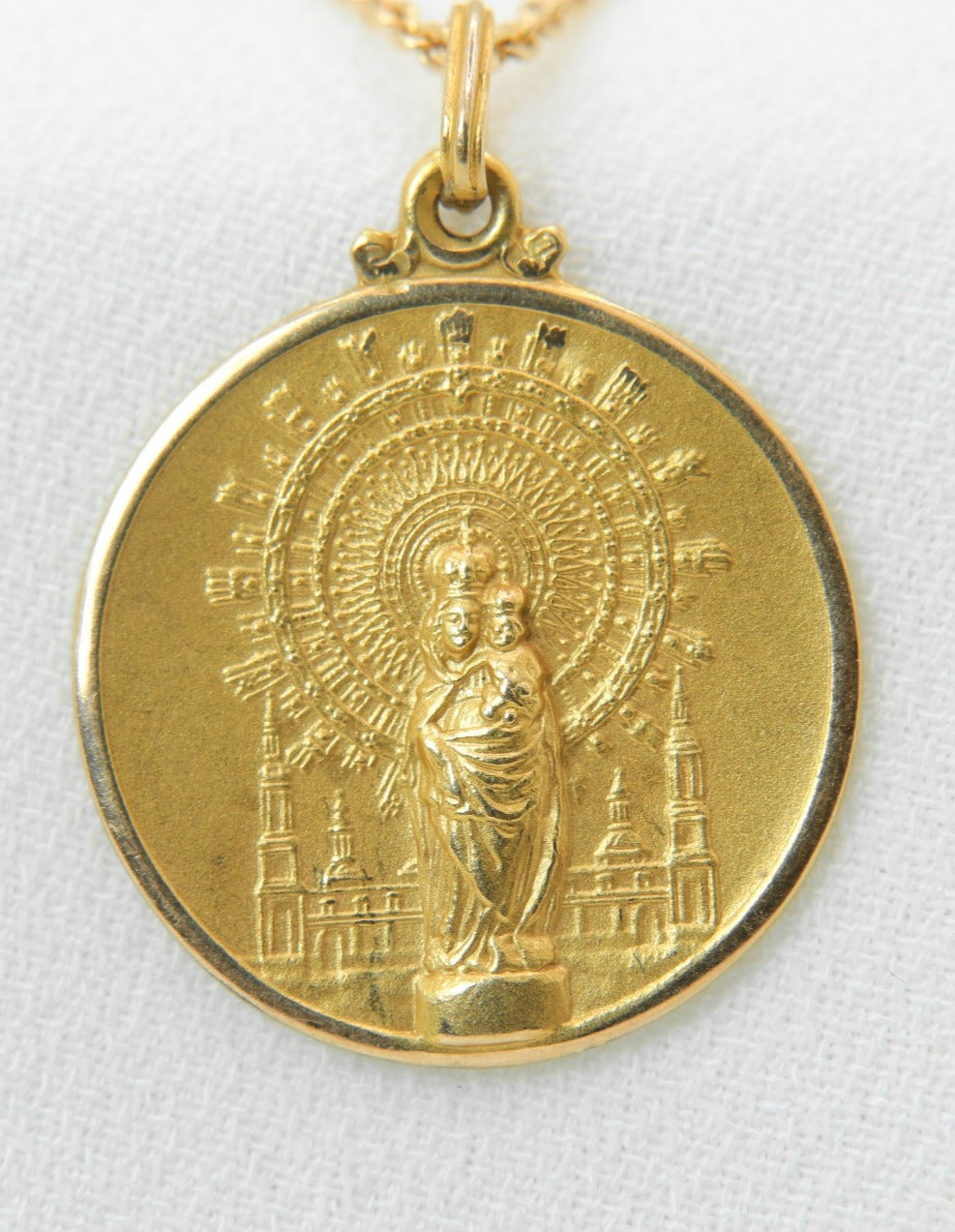 Vintage gold medal pendant depicting a virgin and child