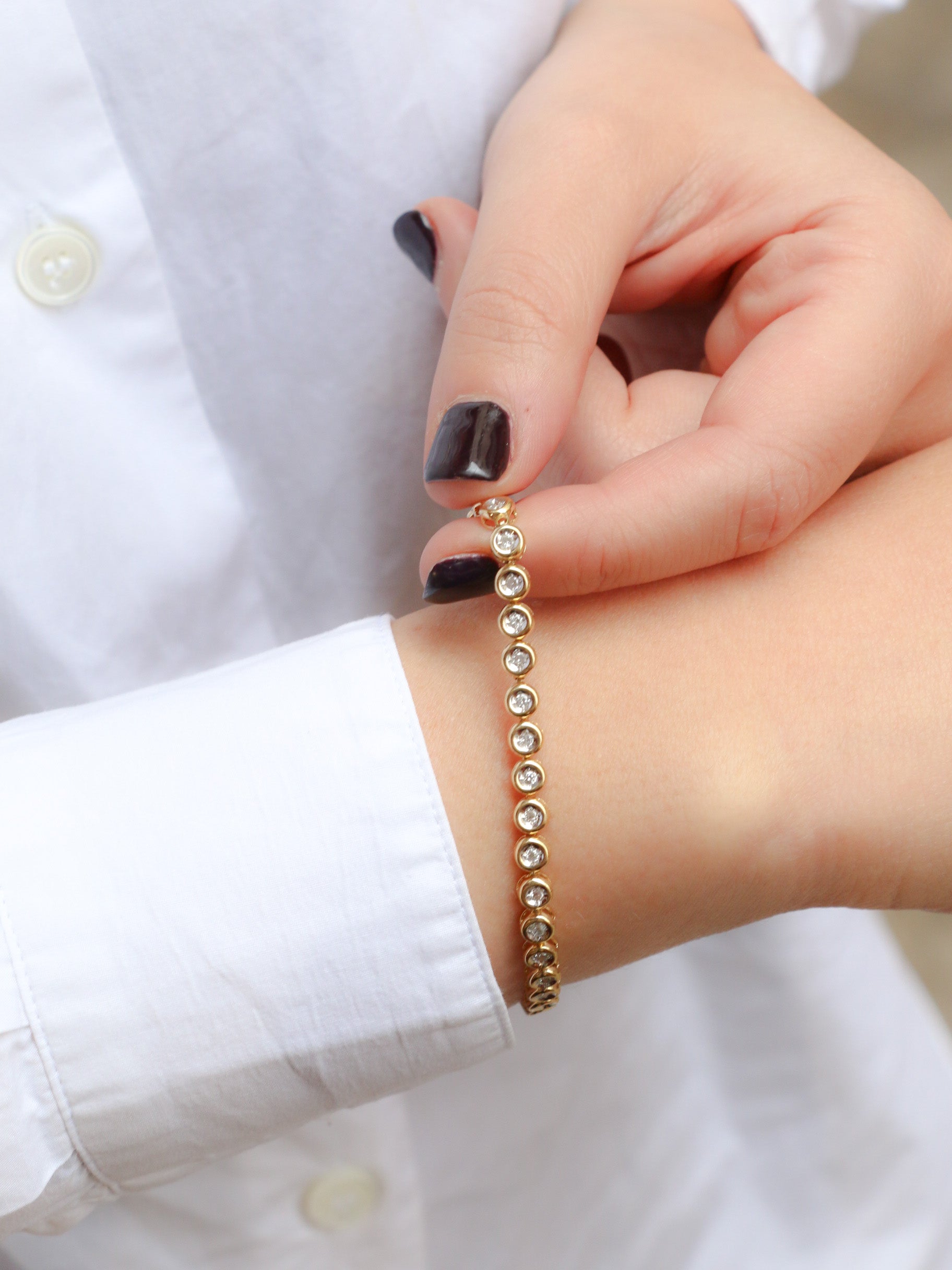 Vintage tennis bracelet in yellow gold and diamonds in bezel setting