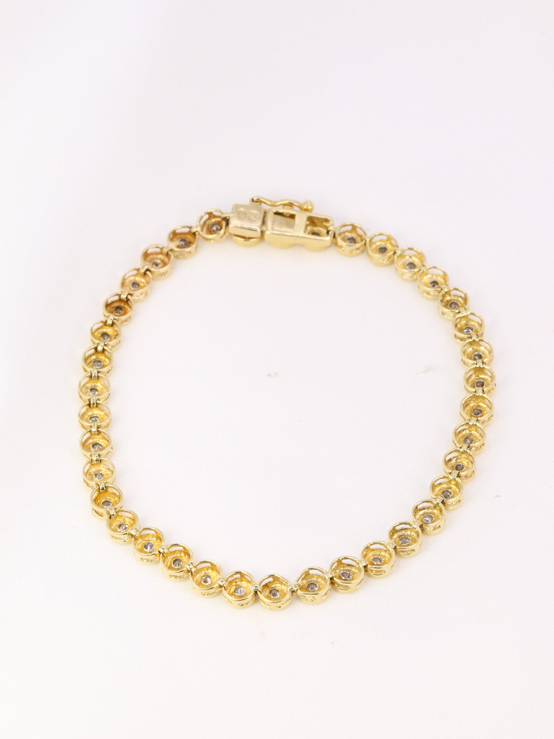 Vintage tennis bracelet in yellow gold and diamonds in bezel setting