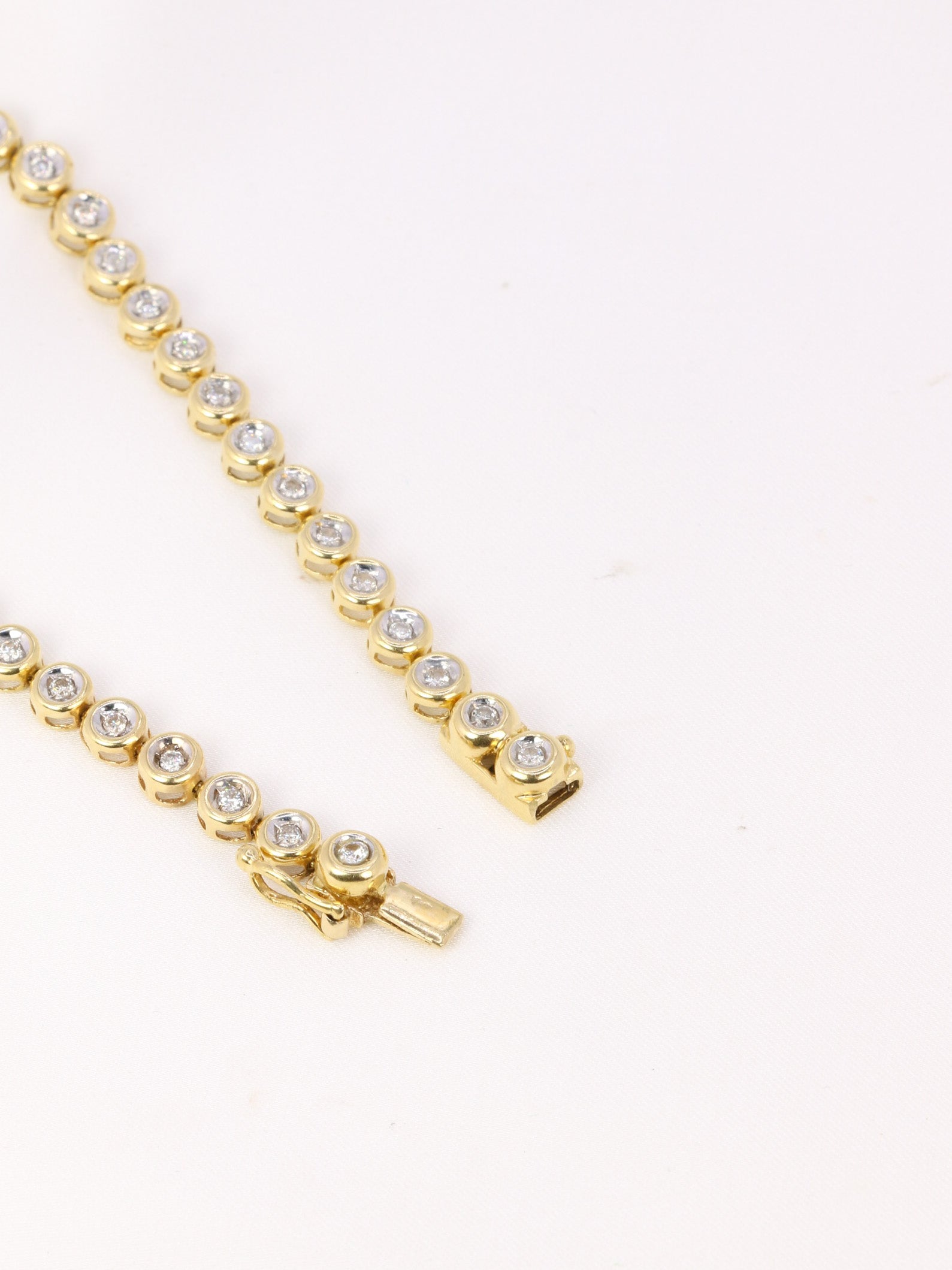 Vintage tennis bracelet in yellow gold and diamonds in bezel setting