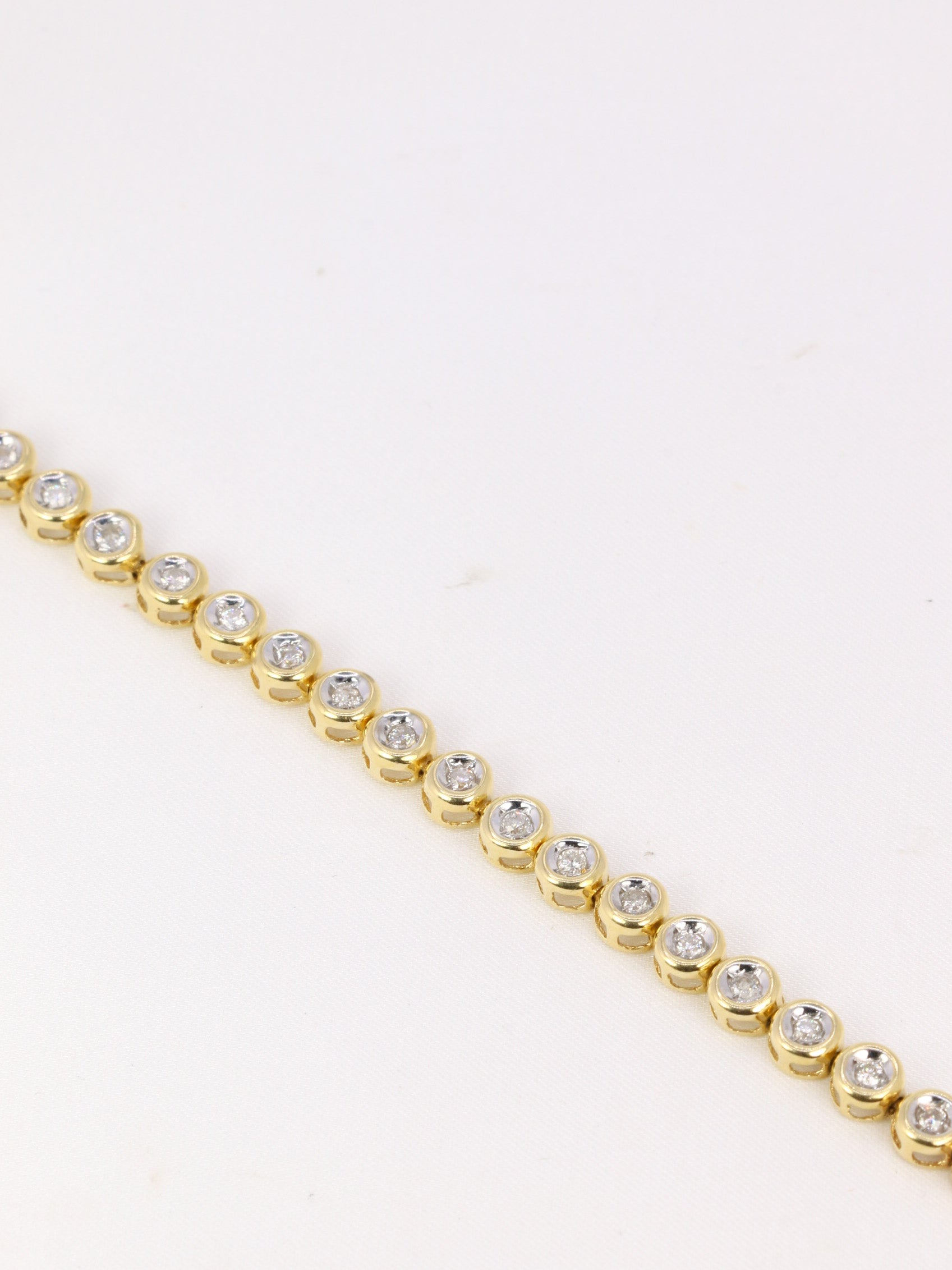 Vintage tennis bracelet in yellow gold and diamonds in bezel setting