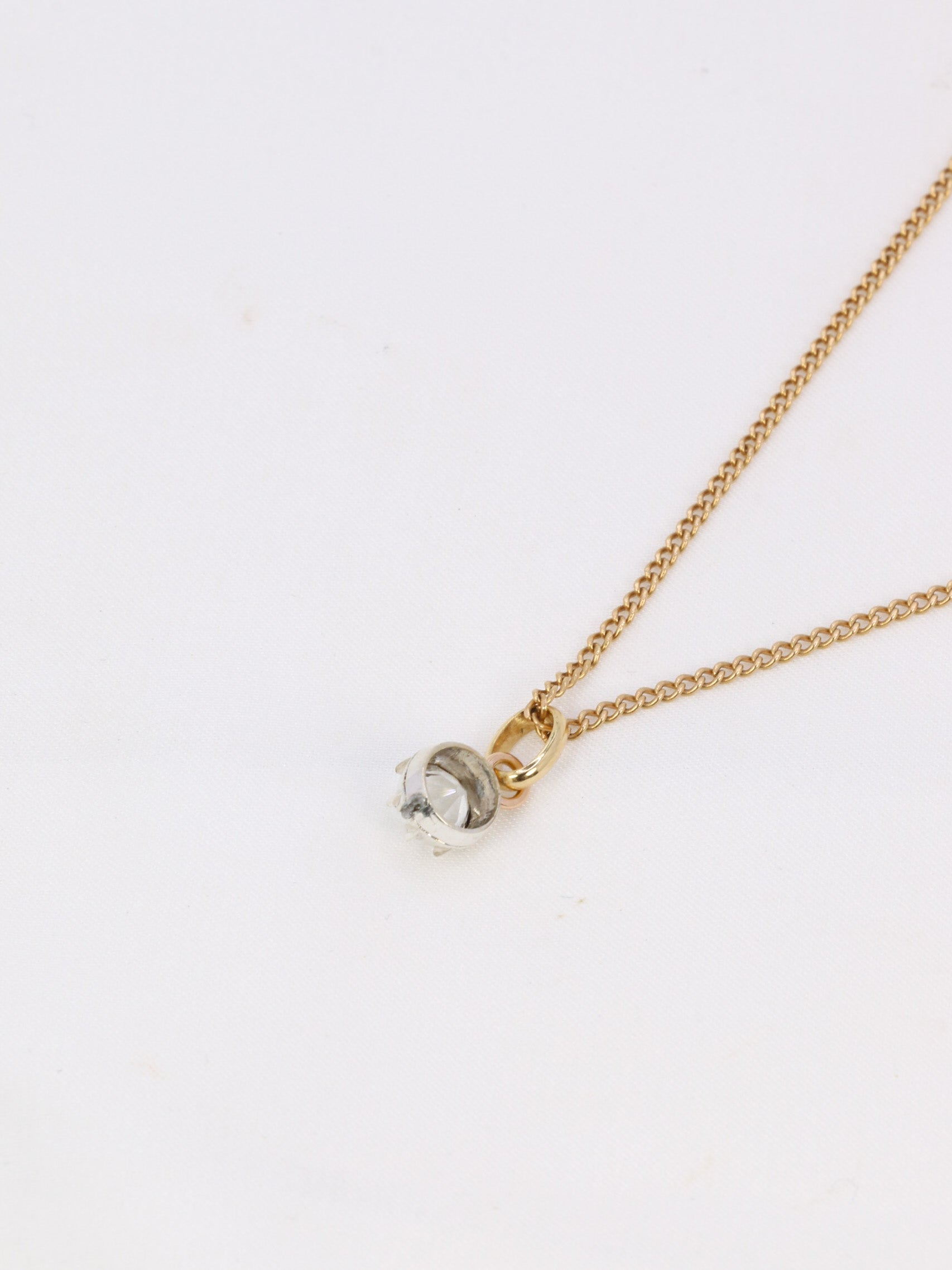 Antique solitaire pendant in gold, silver and Rhine stone on paillon