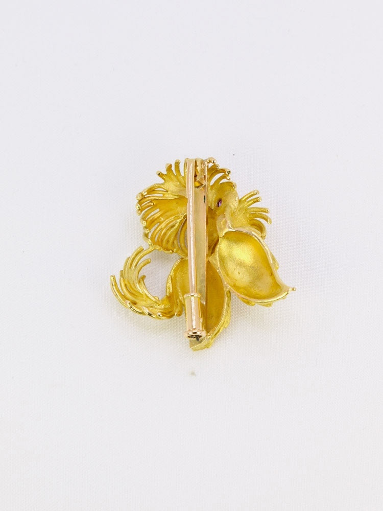 Broche animalière chien or jaune rubis