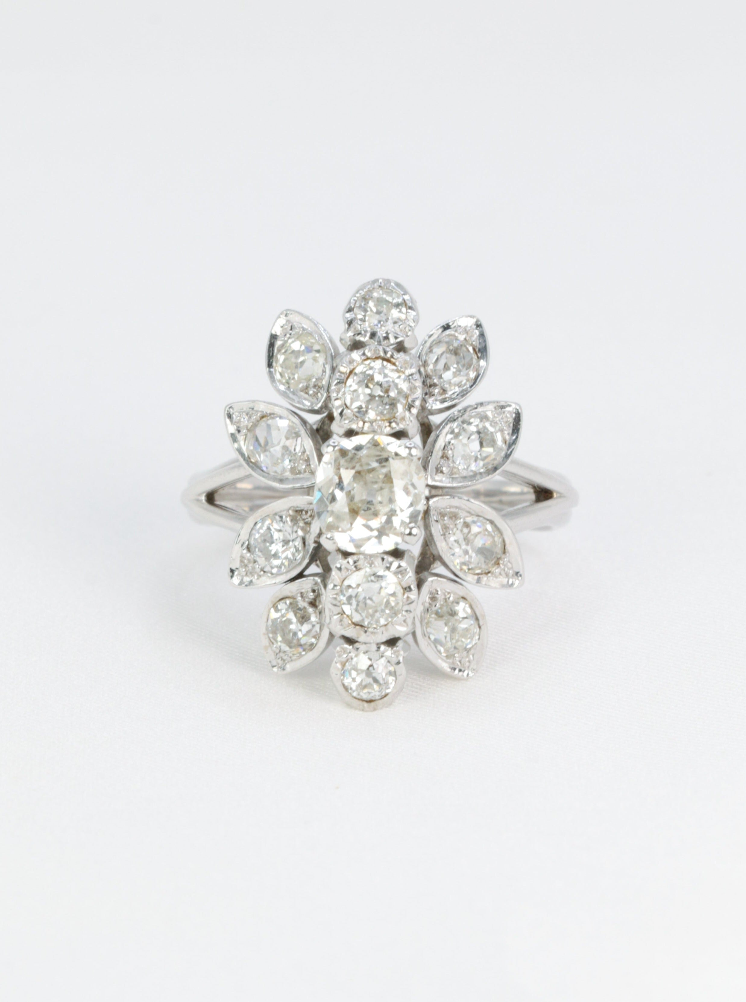 Antique flower ring in gold, platinum and diamonds featuring a floral motif