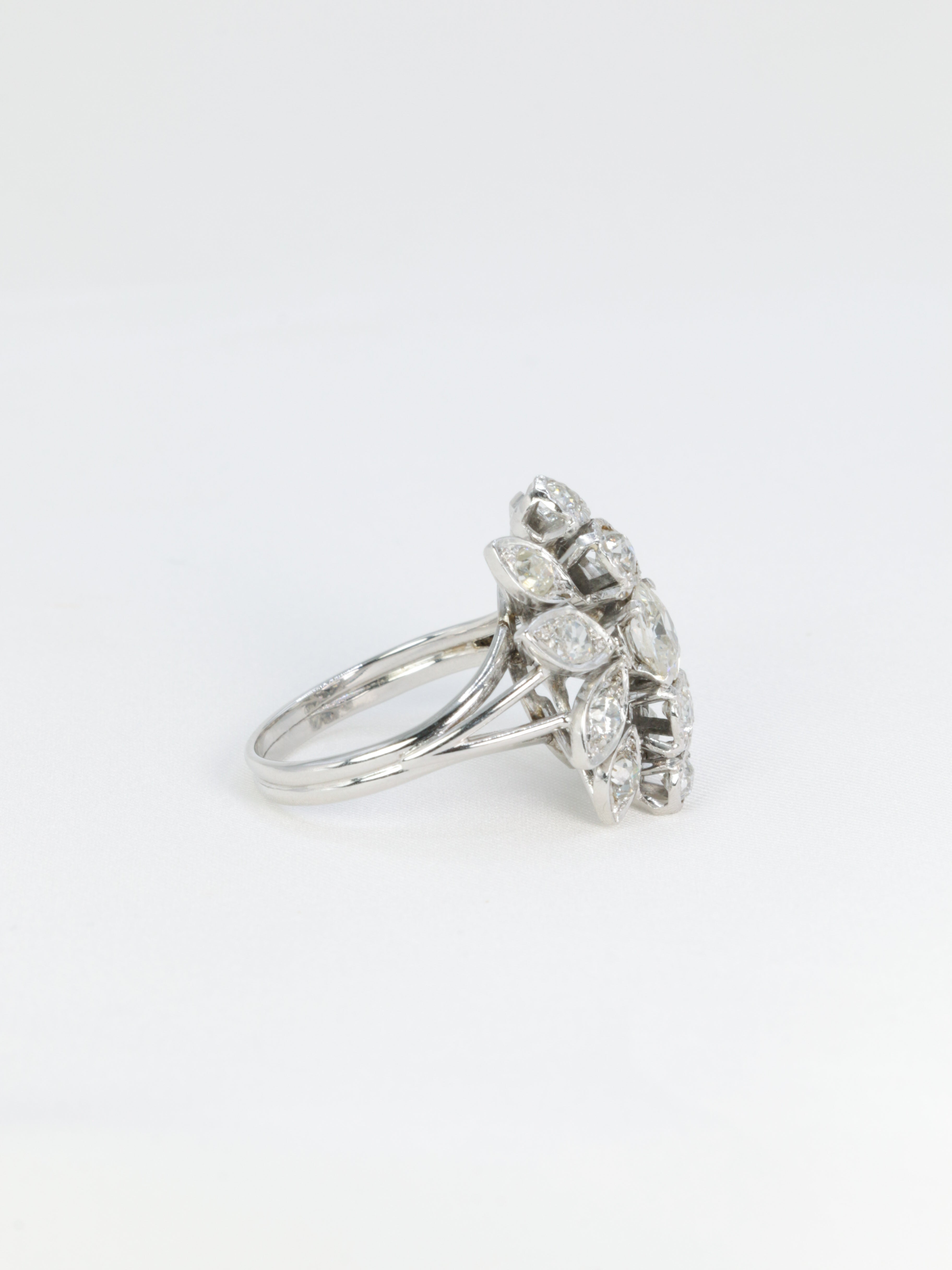 Antique flower ring in gold, platinum and diamonds featuring a floral motif