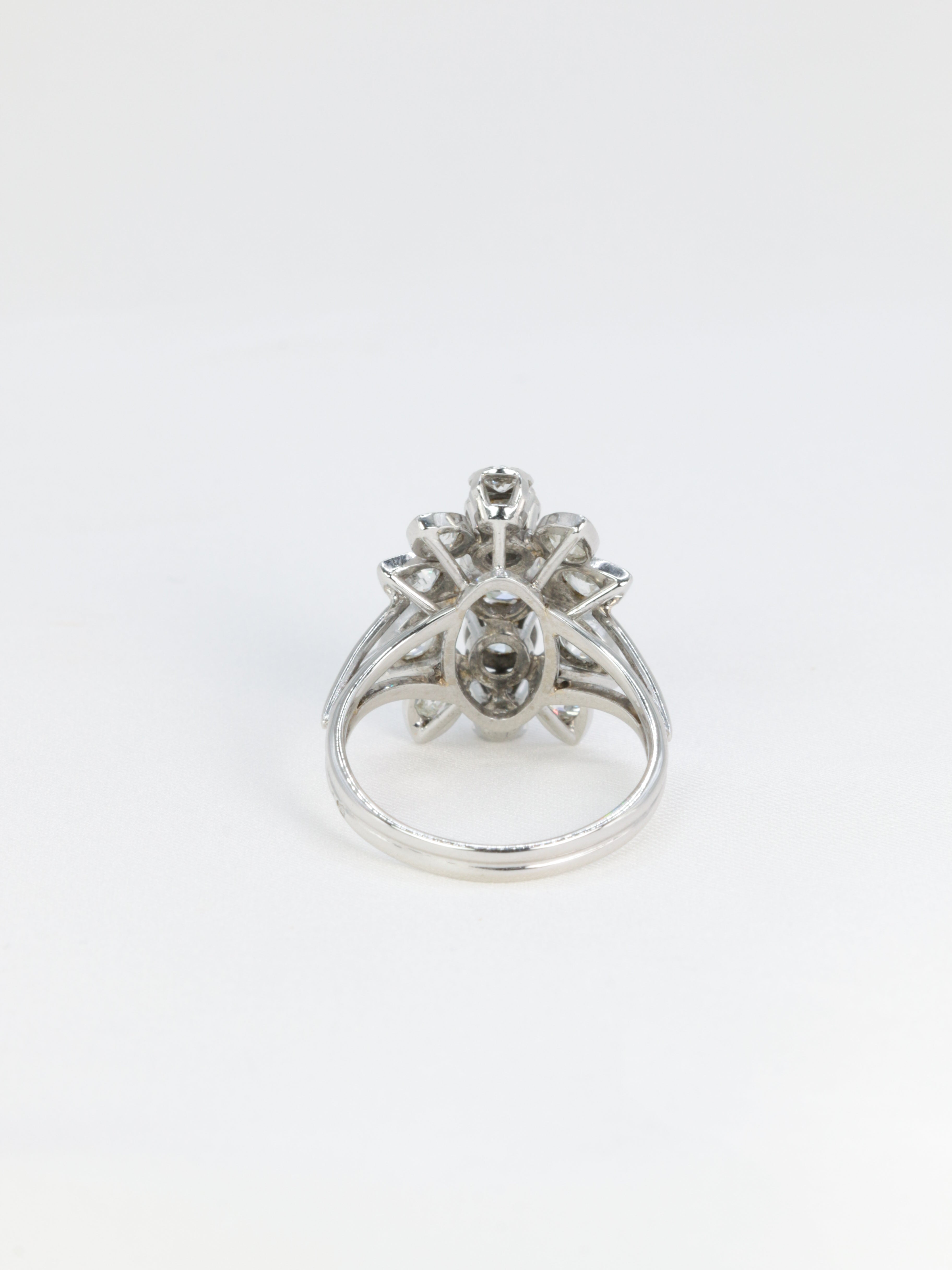 Antique flower ring in gold, platinum and diamonds featuring a floral motif