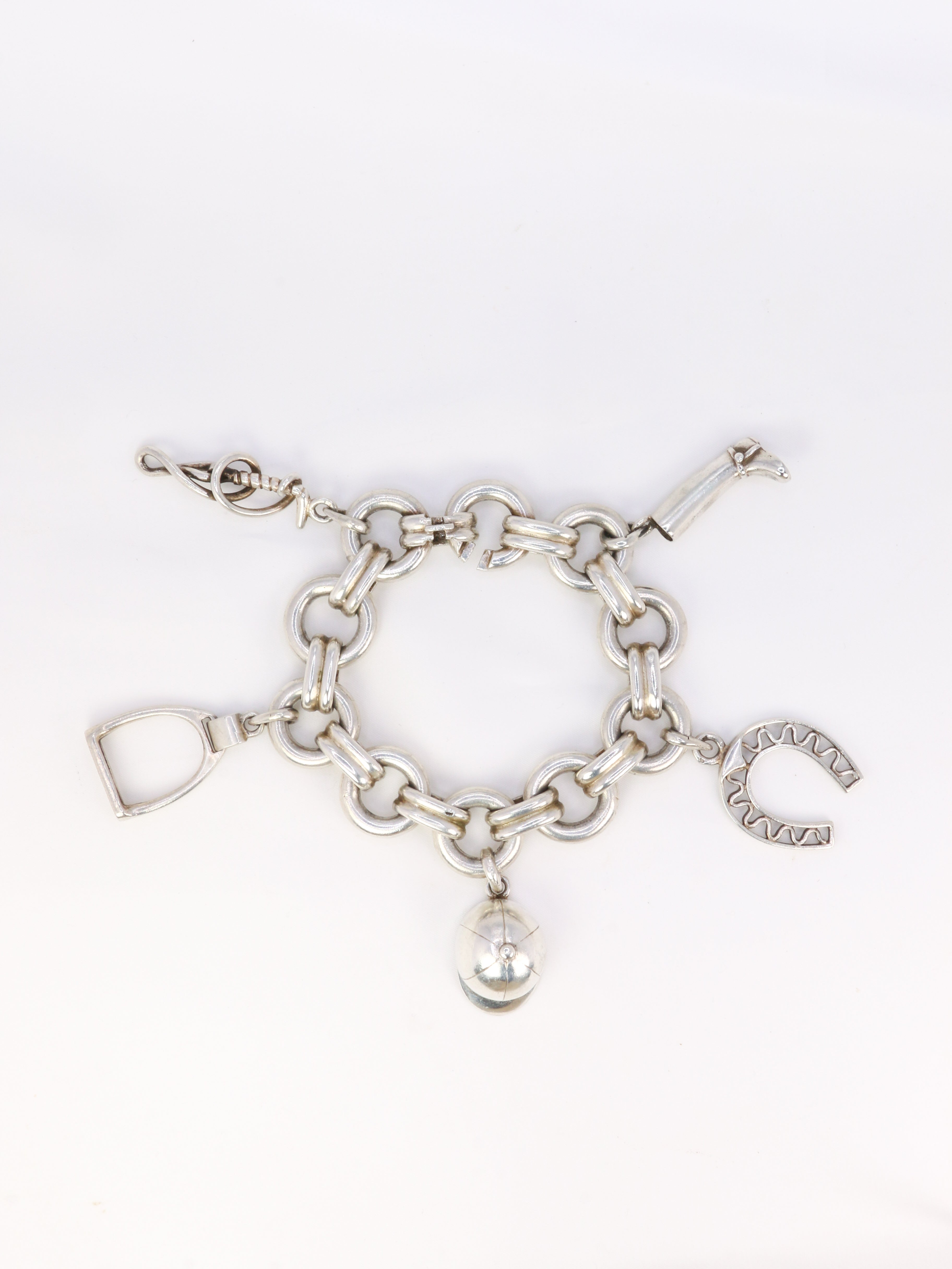 Gaétan de Percin (attributed to HERMES) Silver bracelet and horse-racing theme charms