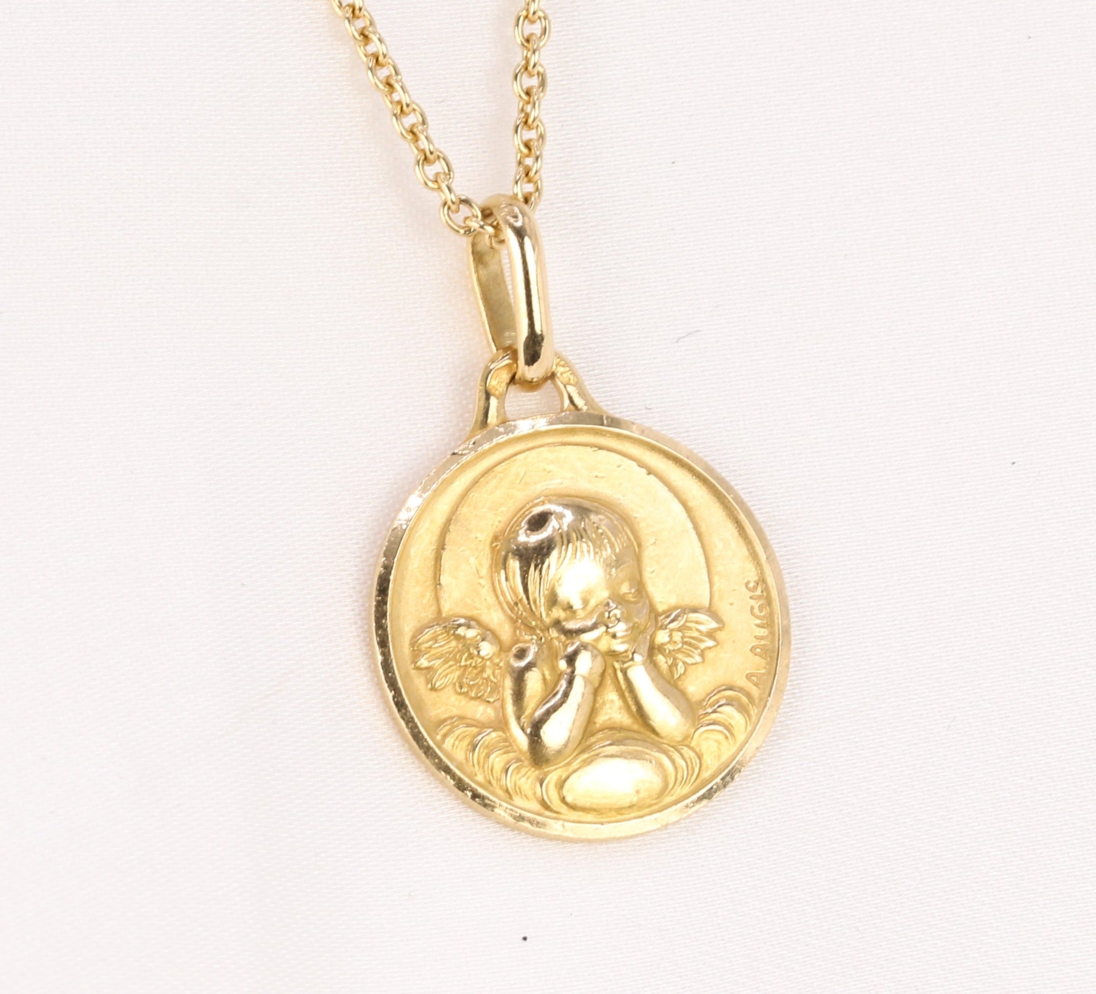 Vintage Augis medal in yellow gold depicting an angel with a quiver