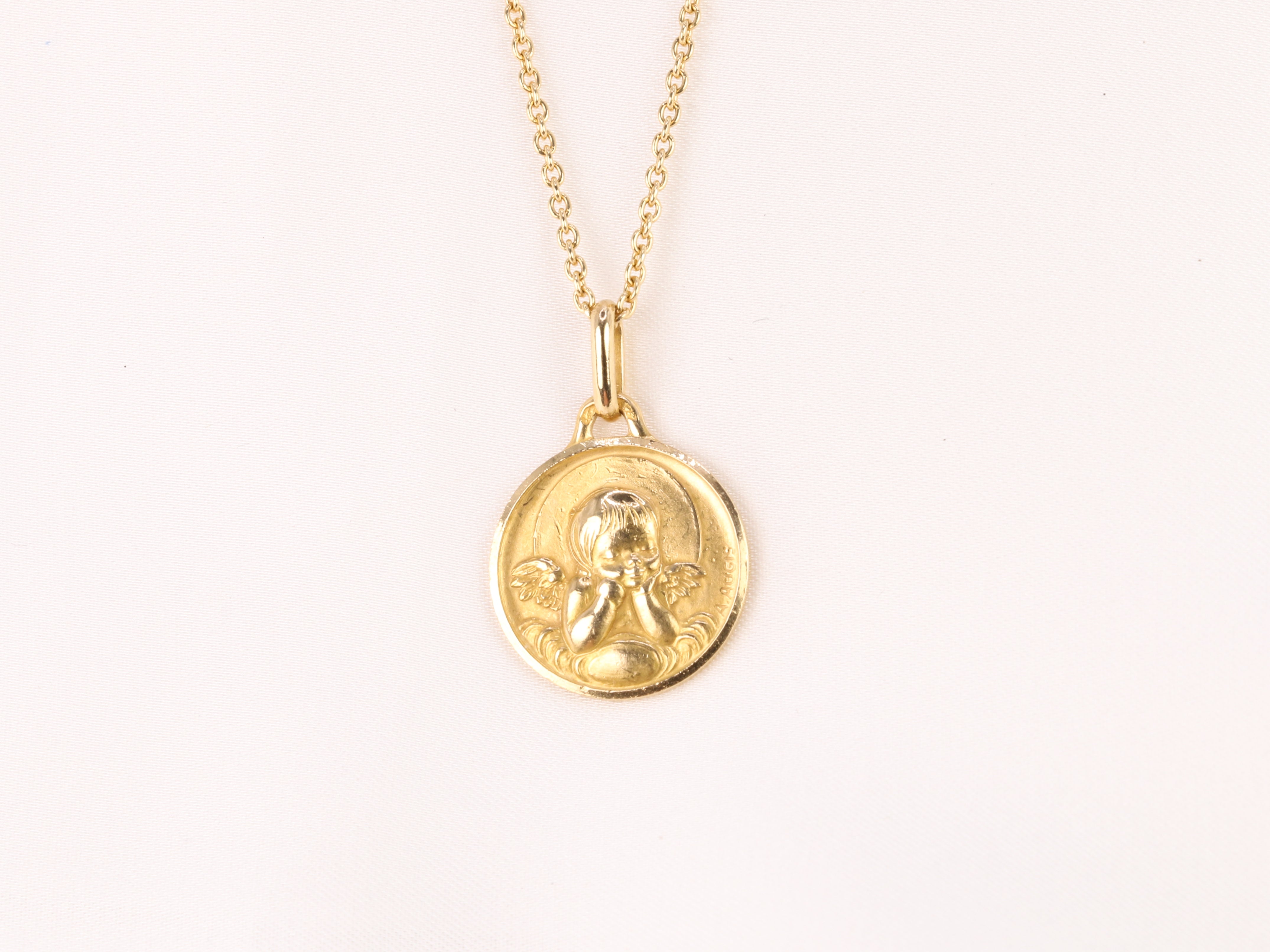 Vintage Augis medal in yellow gold depicting an angel with a quiver