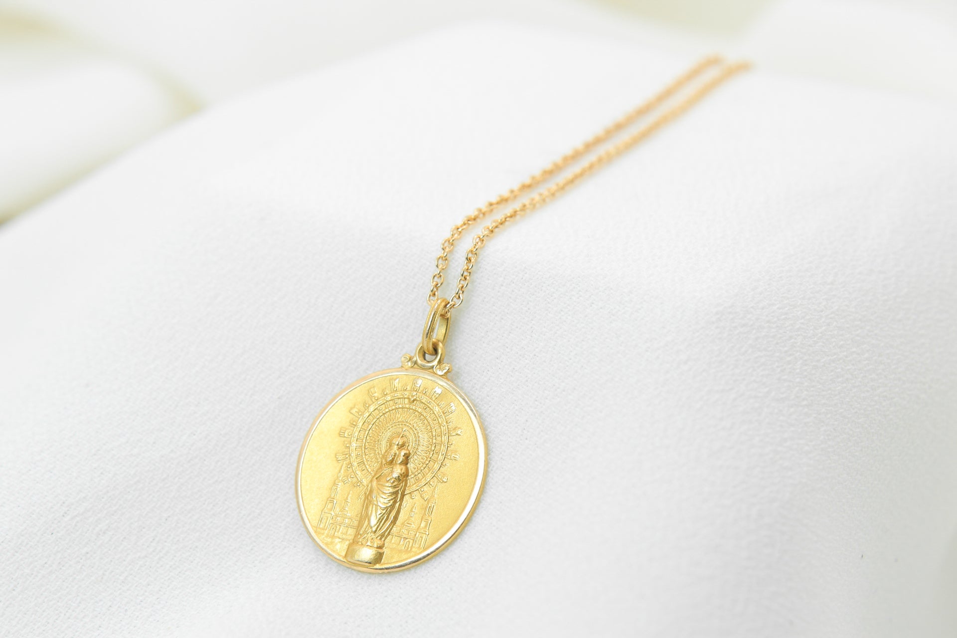 Vintage gold medal pendant depicting a virgin and child