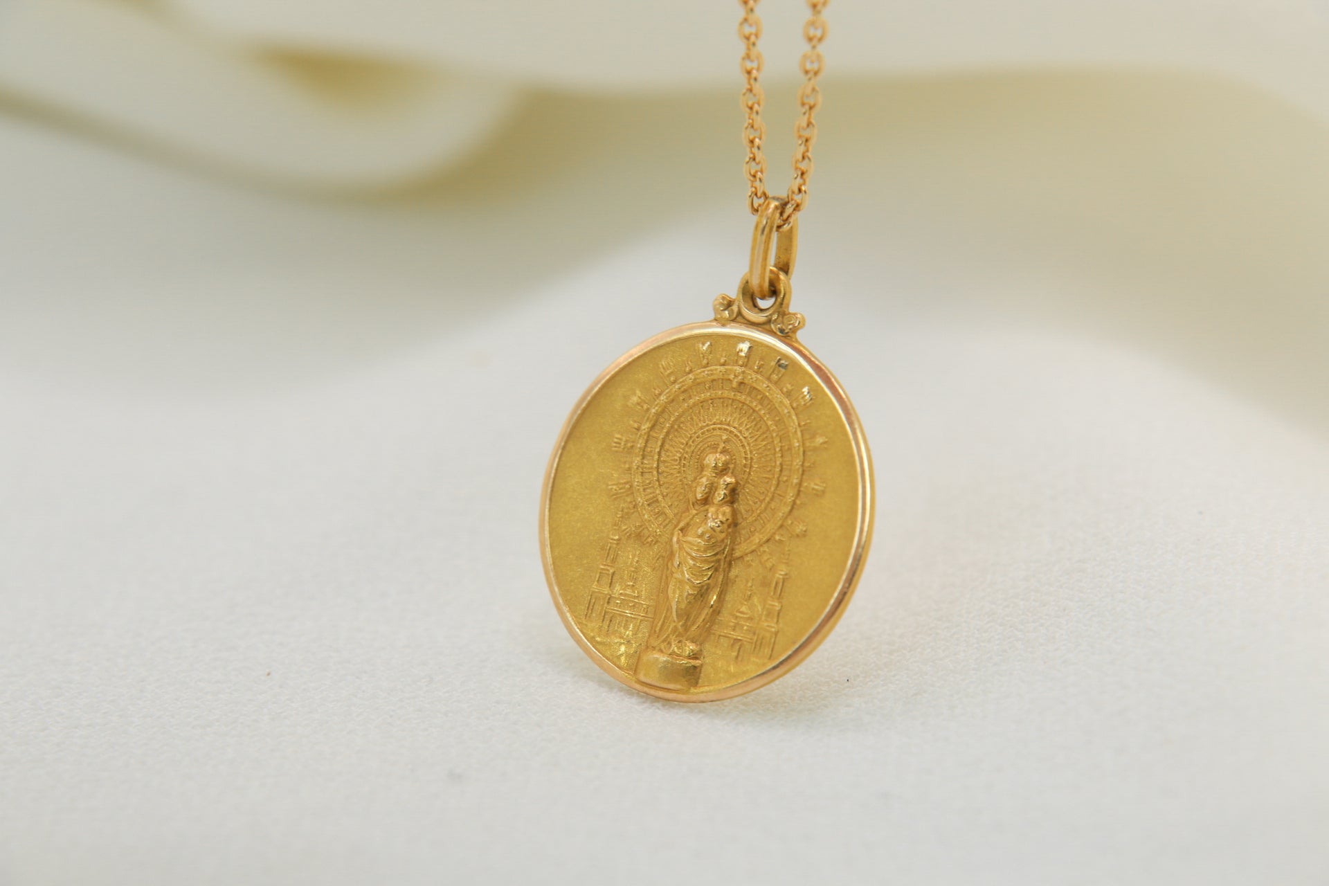 Vintage gold medal pendant depicting a virgin and child