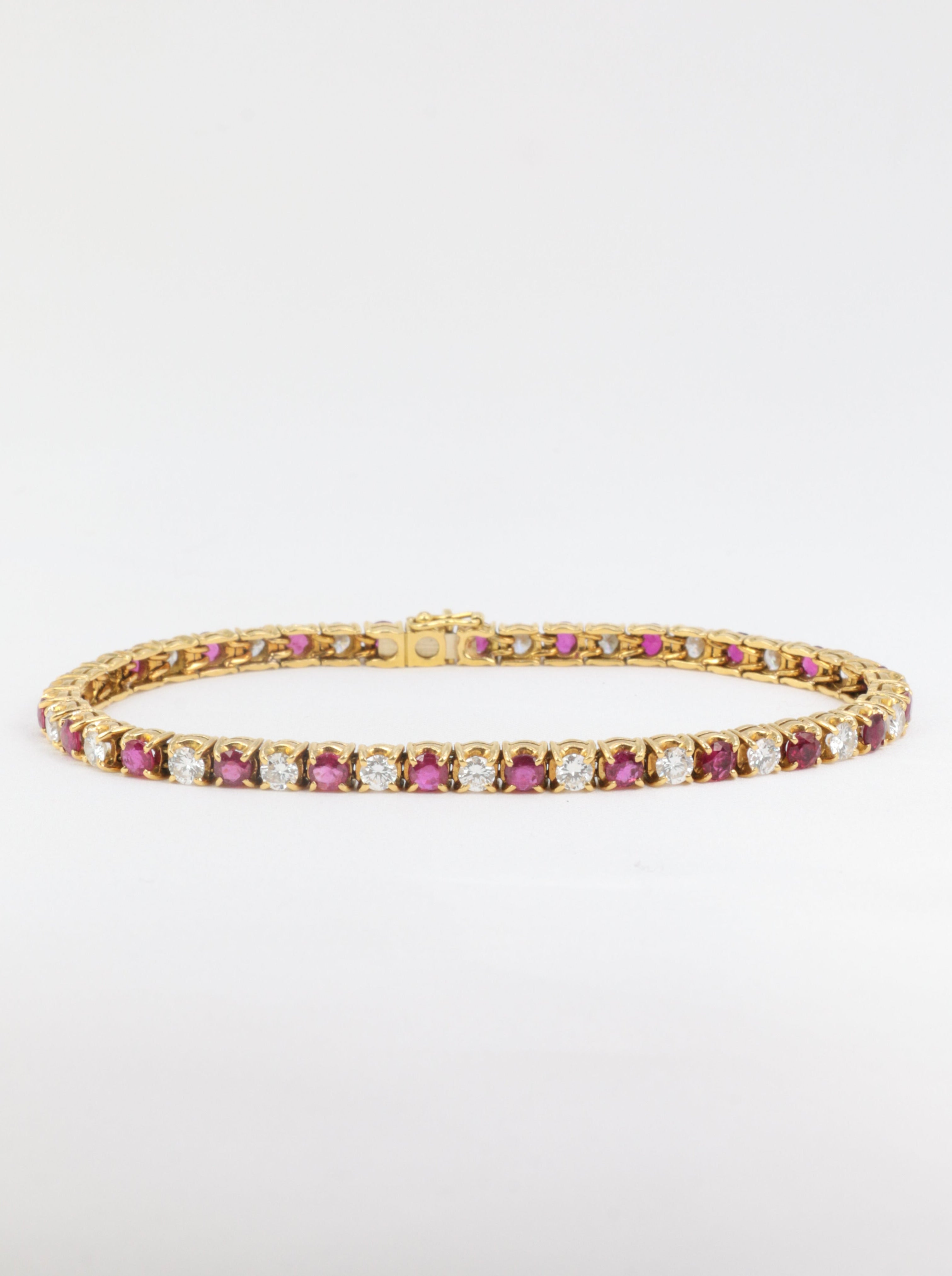 Vintage tennis bracelet in gold, rubies and diamonds