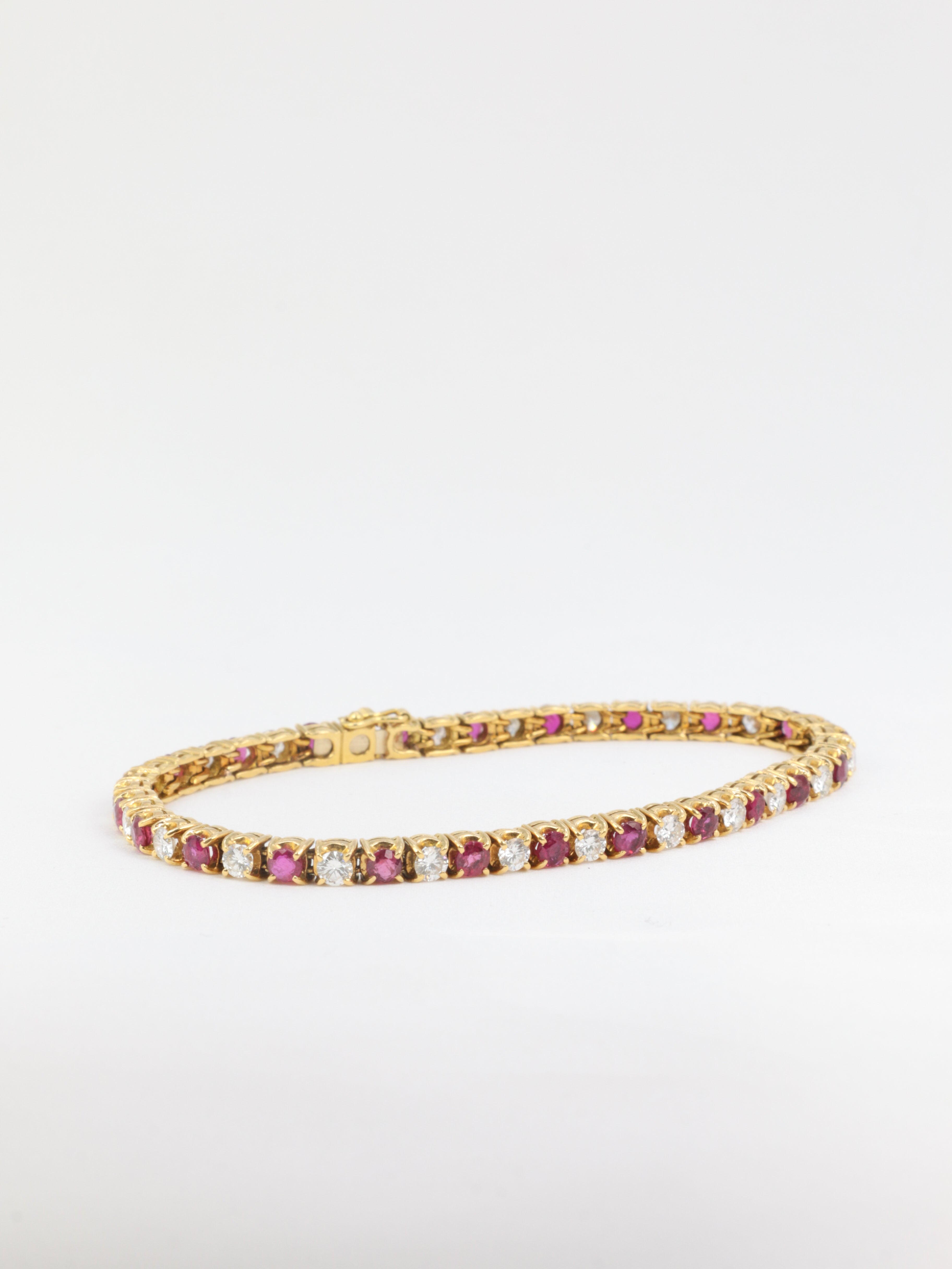 Vintage tennis bracelet in gold, rubies and diamonds