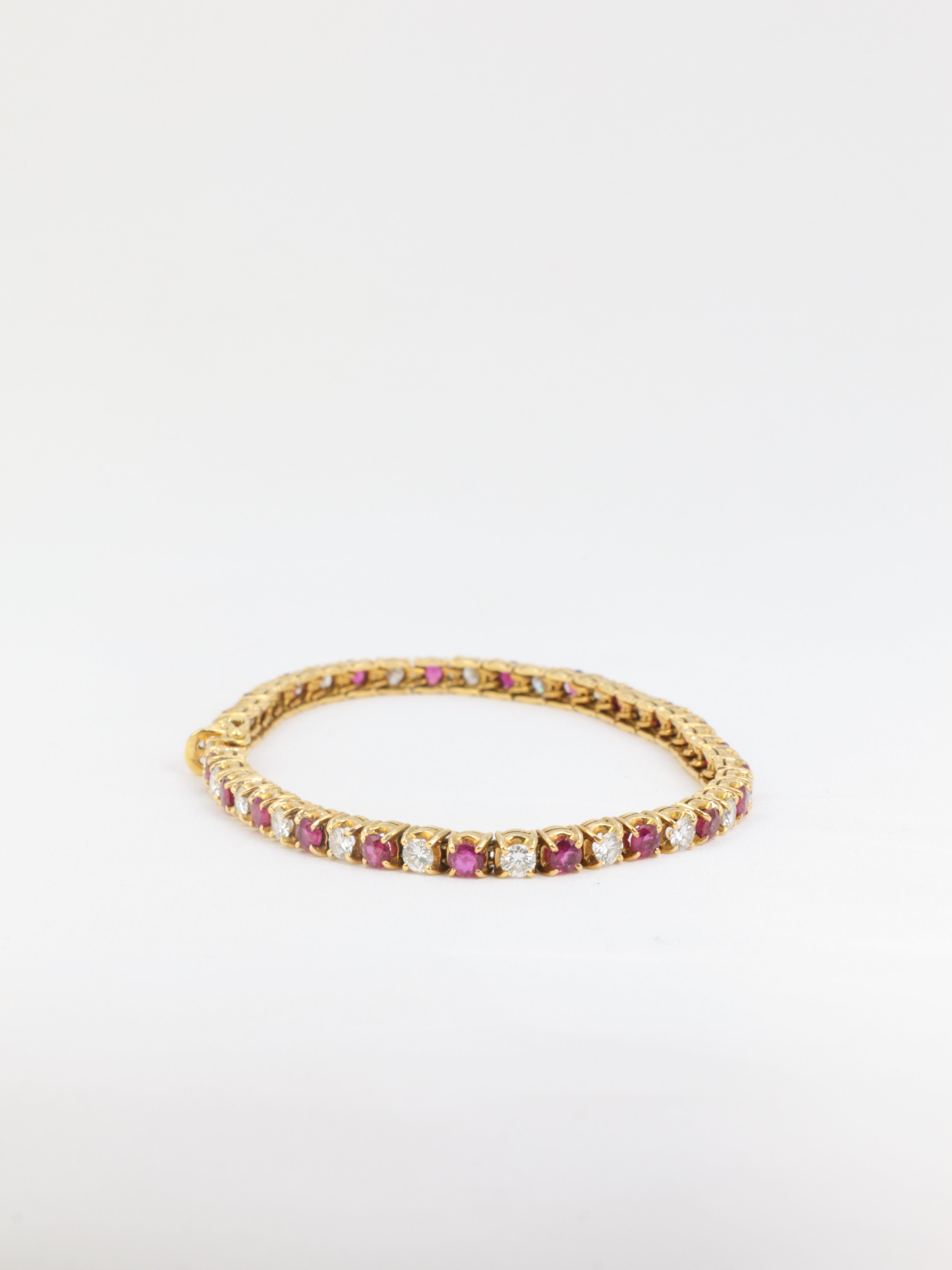 Vintage tennis bracelet in gold, rubies and diamonds