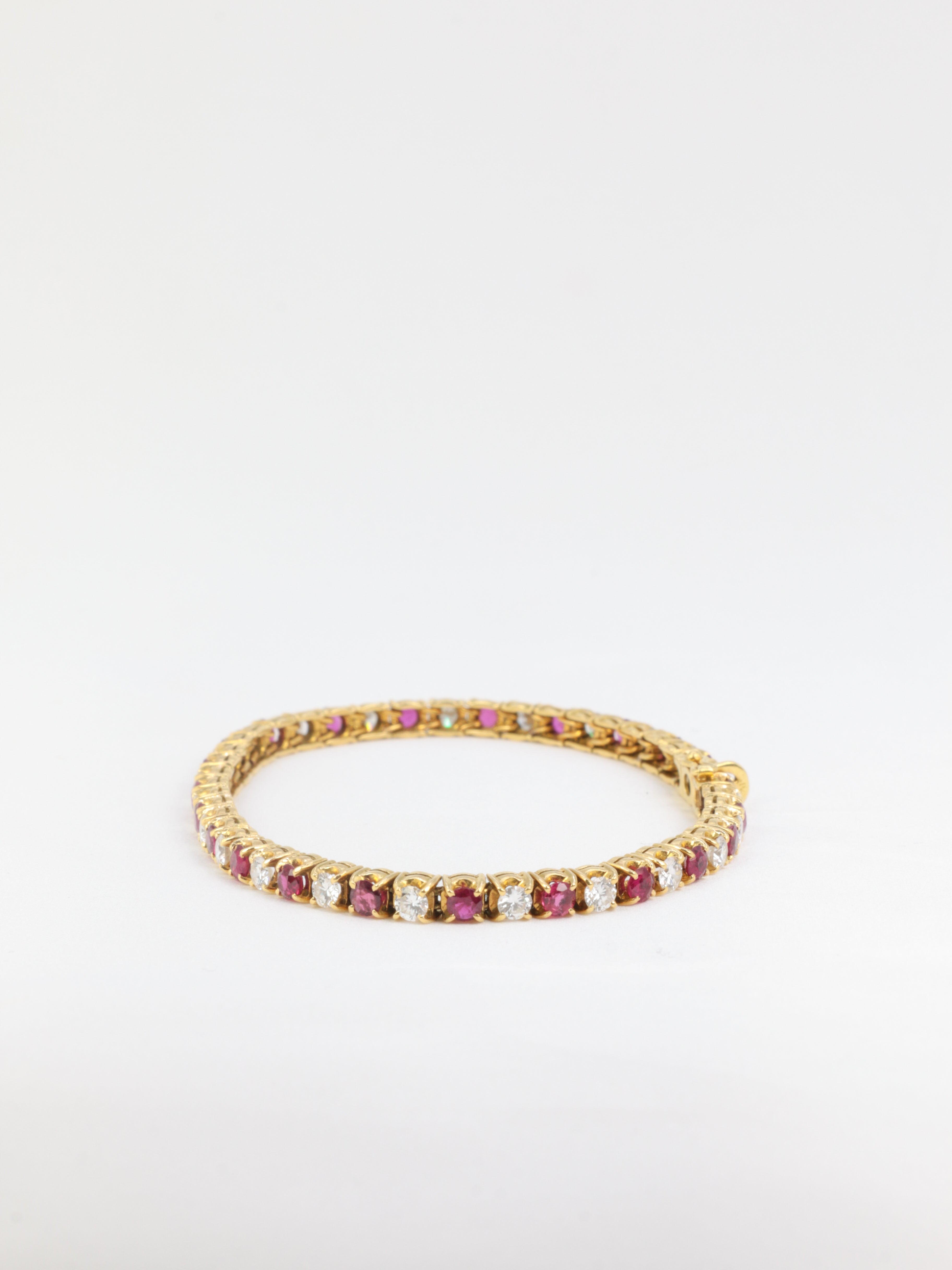 Vintage tennis bracelet in gold, rubies and diamonds