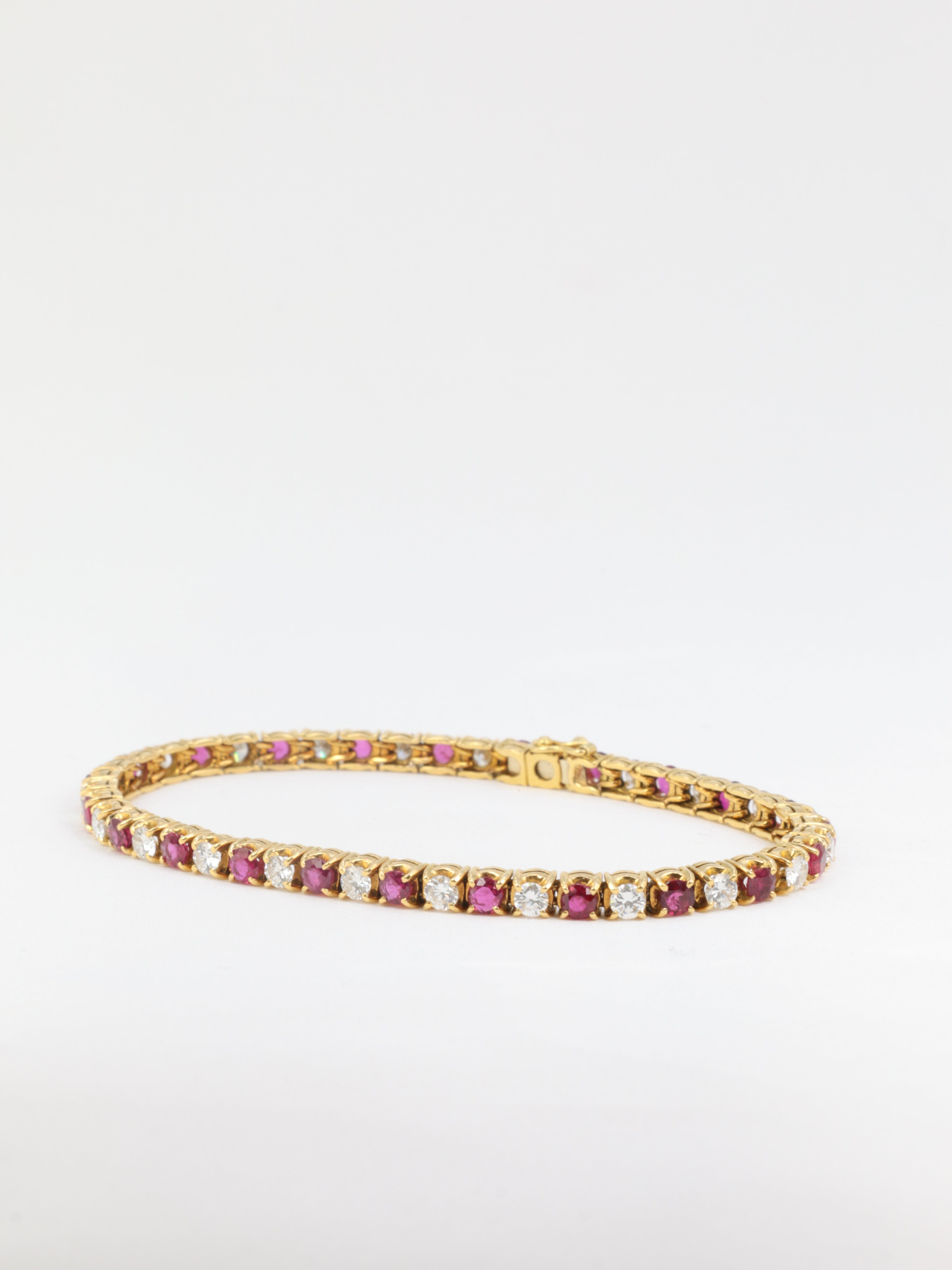 Vintage tennis bracelet in gold, rubies and diamonds