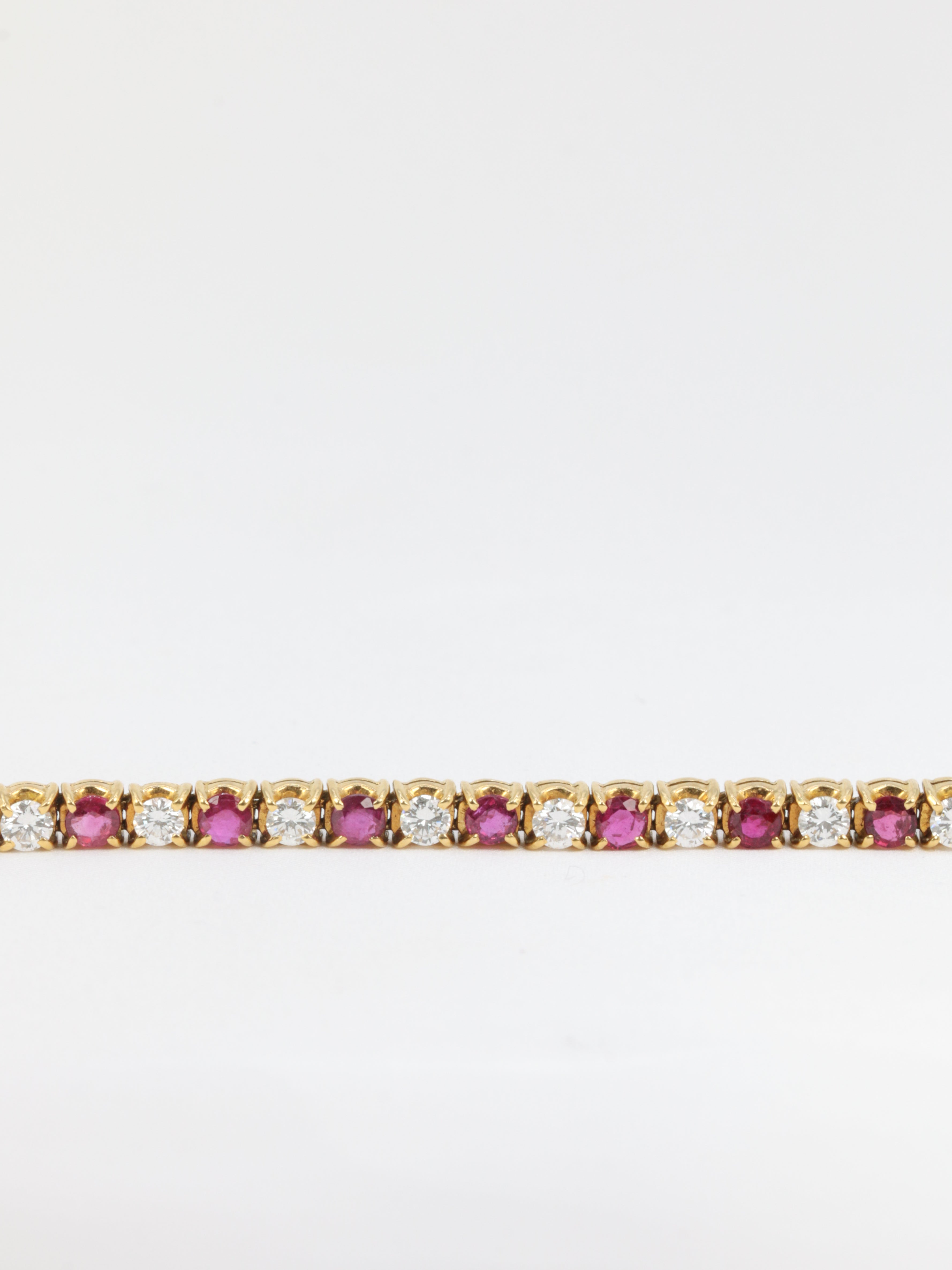 Vintage tennis bracelet in gold, rubies and diamonds