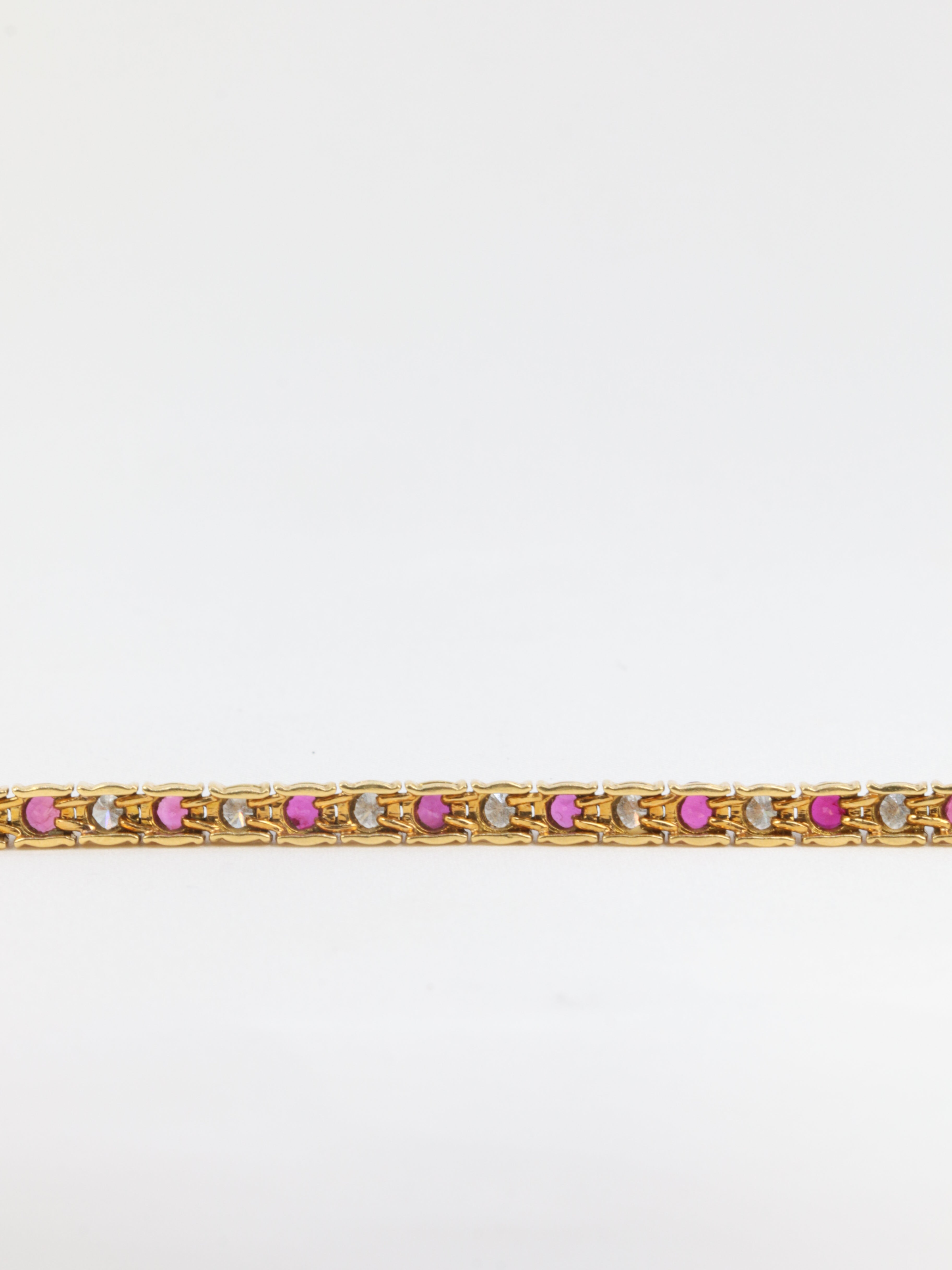 Vintage tennis bracelet in gold, rubies and diamonds