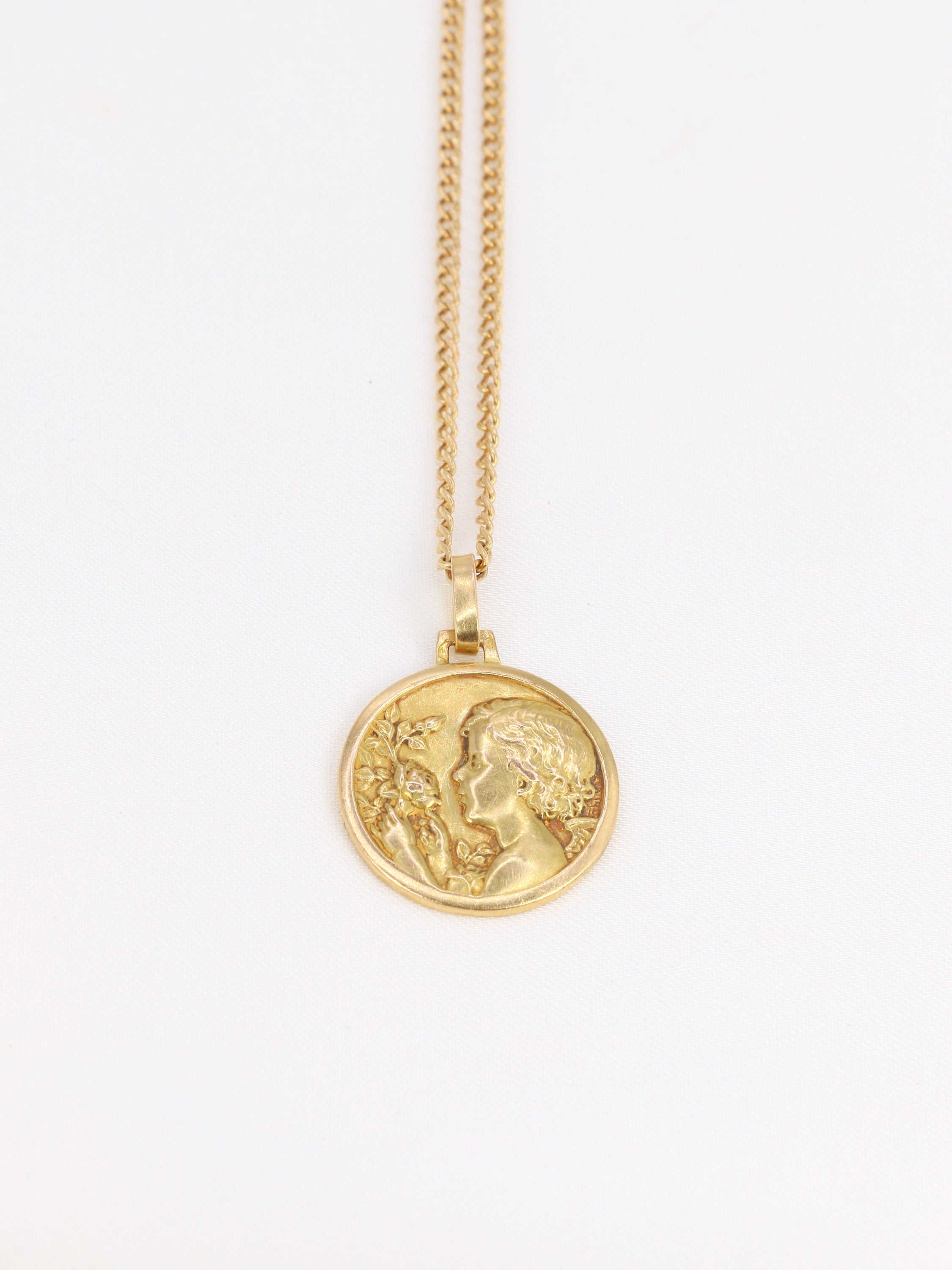 Old gold medal depicting the little girl with the rose